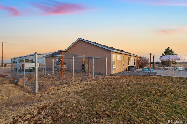 exterior space featuring central AC unit and fence