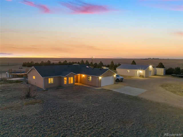 ranch-style house with concrete driveway and an attached garage