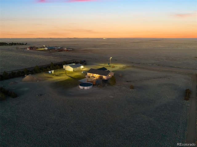 aerial view at dusk featuring a rural view