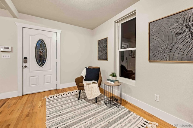 foyer featuring hardwood / wood-style floors and a textured ceiling