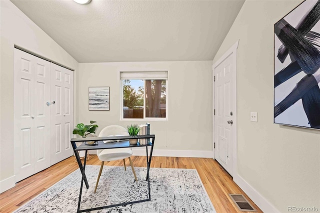 office area with hardwood / wood-style floors and vaulted ceiling