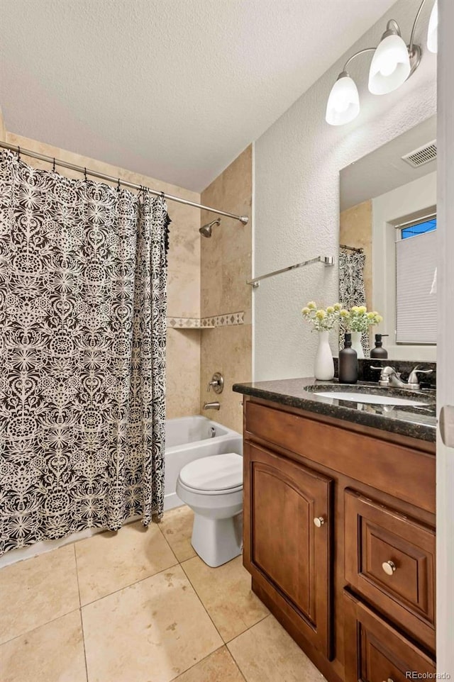 full bathroom with shower / tub combo with curtain, vanity, toilet, tile patterned floors, and a textured ceiling