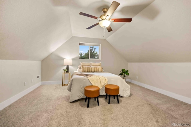 carpeted bedroom with ceiling fan and vaulted ceiling