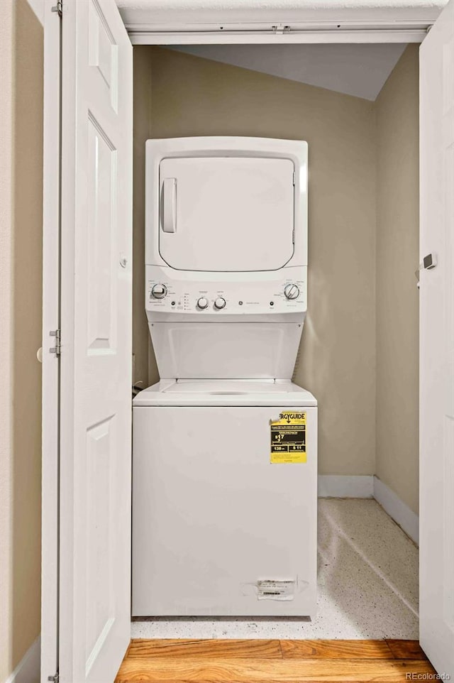 laundry room featuring stacked washer and clothes dryer