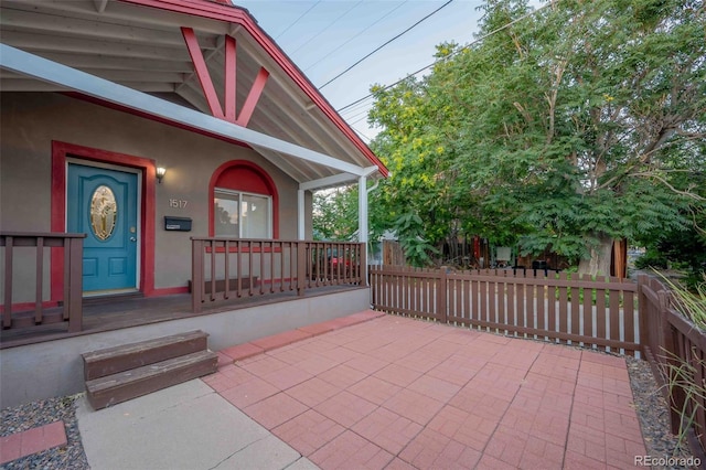 view of patio featuring fence and covered porch