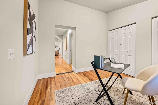 home office featuring light wood finished floors and baseboards