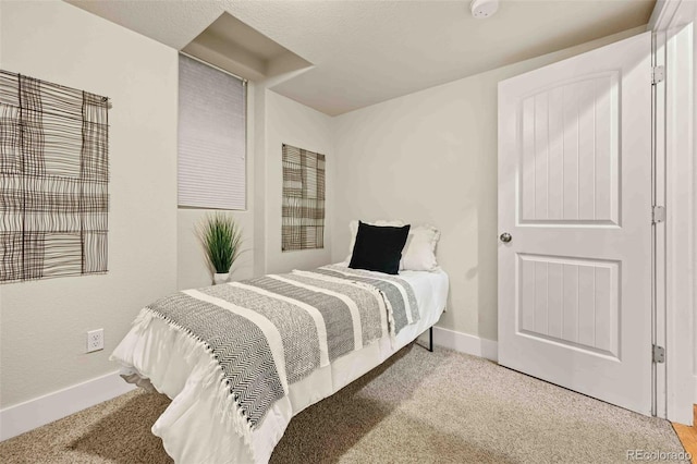 bedroom featuring baseboards and carpet