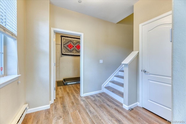 31112 Black Eagle Dr Unit 101, Evergreen, CO 80439 - stairs featuring a baseboard heating unit and wood finished floors