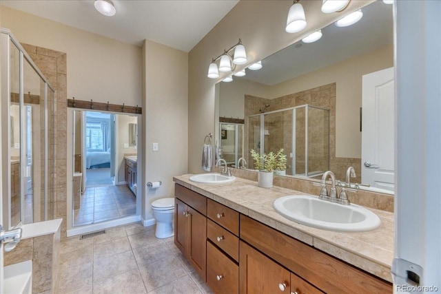 31112 Black Eagle Dr Unit 101, Evergreen, CO 80439 - ensuite bathroom with double vanity, tile patterned floors, and a shower stall