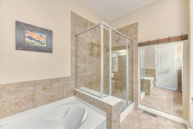 31112 Black Eagle Dr Unit 101, Evergreen, CO 80439 - bathroom with a bath, a shower stall, and tile patterned flooring