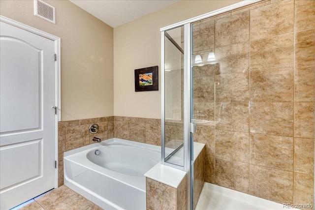 31112 Black Eagle Dr Unit 101, Evergreen, CO 80439 - bathroom featuring a garden tub, a stall shower, and tile patterned flooring