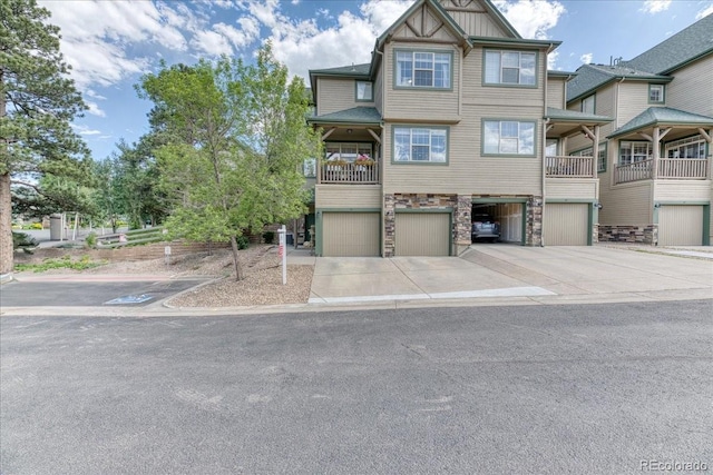 31112 Black Eagle Dr Unit 101, Evergreen, CO 80439 - multi unit property with a garage, stone siding, driveway, and board and batten siding
