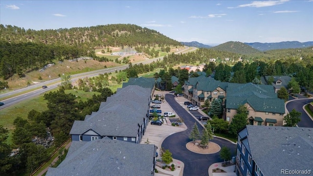 31112 Black Eagle Dr Unit 101, Evergreen, CO 80439 - drone / aerial view of mountains and a forest