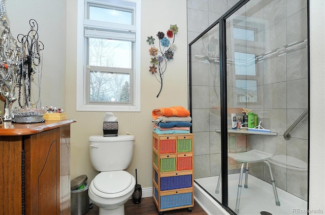 full bathroom with a shower stall, toilet, and baseboards