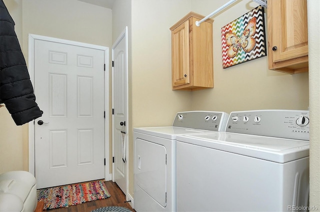 laundry room featuring cabinet space, dark wood-type flooring, and washing machine and dryer