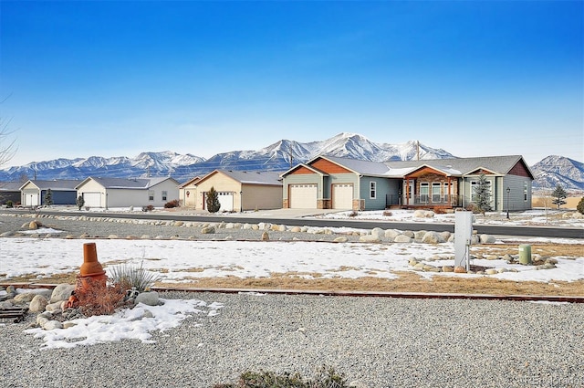 view of front of property with a mountain view and a garage