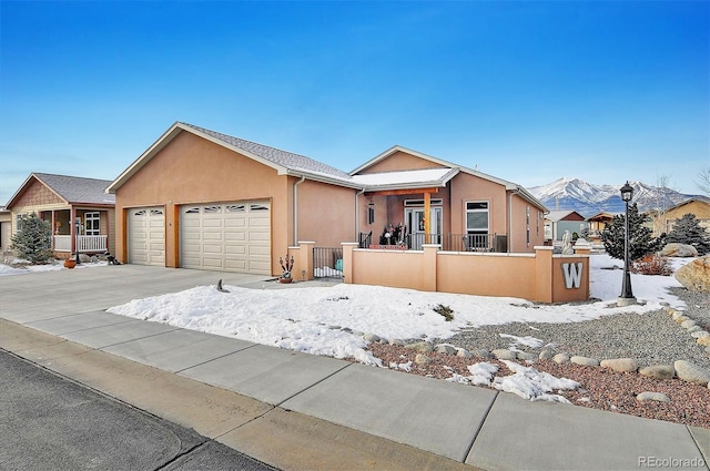 view of front facade with a mountain view and a garage