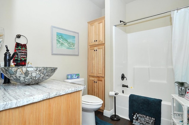 full bathroom featuring vanity, toilet, shower / tub combo with curtain, and wood finished floors