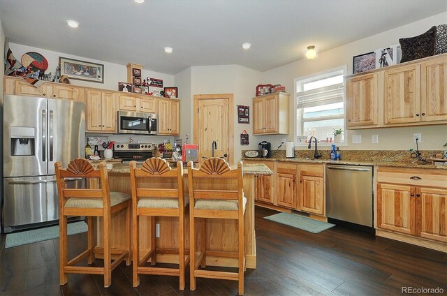 27665 County Road 313 Unit 11, Buena Vista, CO 81211 - kitchen featuring stainless steel appliances, light stone counters, dark wood-style floors, a breakfast bar, and recessed lighting