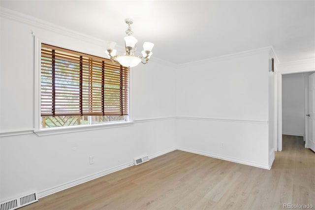 971 S Ironton St, Aurora, CO 80012 - spare room featuring a chandelier, light wood-style flooring, and crown molding