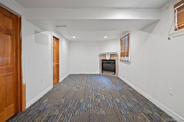 971 S Ironton St, Aurora, CO 80012 - unfurnished living room with dark colored carpet, a tiled fireplace, and recessed lighting