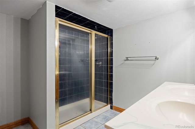 971 S Ironton St, Aurora, CO 80012 - full bathroom featuring a stall shower, tile patterned flooring, and double vanity