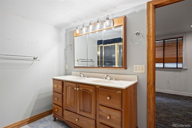 971 S Ironton St, Aurora, CO 80012 - full bathroom with double vanity, a shower with door, and tile patterned flooring