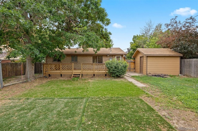 971 S Ironton St, Aurora, CO 80012 - rear view of house with a deck, a fenced backyard, a shed, and brick siding