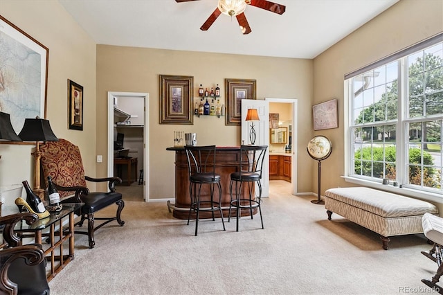 2992 W Long Dr Unit A, Littleton, CO 80120 - living area featuring light colored carpet, plenty of natural light, a ceiling fan, and a dry bar