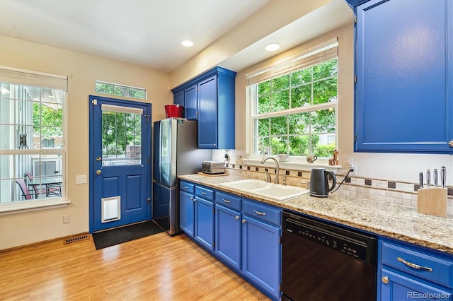 2992 W Long Dr Unit A, Littleton, CO 80120 - kitchen with dishwashing machine, blue cabinetry, freestanding refrigerator, plenty of natural light, and recessed lighting
