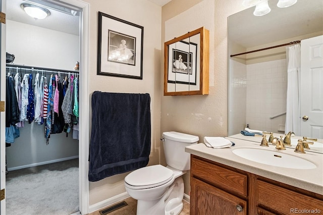 2992 W Long Dr Unit A, Littleton, CO 80120 - full bathroom featuring vanity, a walk in closet, and a shower with curtain