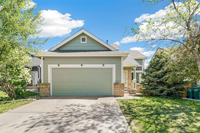 view of front of home with brick siding, concrete driveway, an attached garage, and a front yard