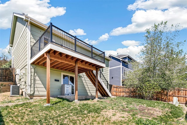 back of house with a wooden deck, a cooling unit, and stairway