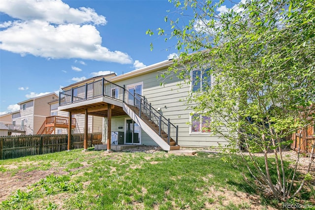 rear view of house with stairs and a deck