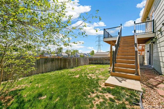 view of yard featuring stairway and a deck