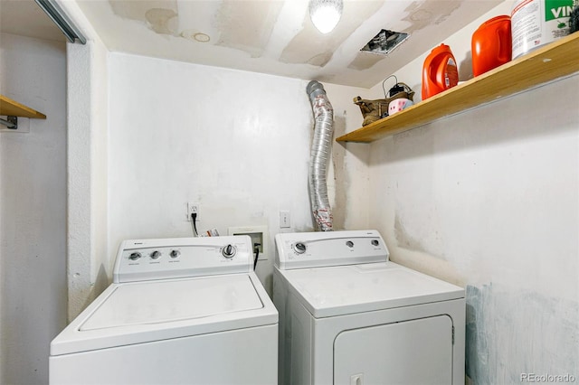 clothes washing area with washing machine and dryer