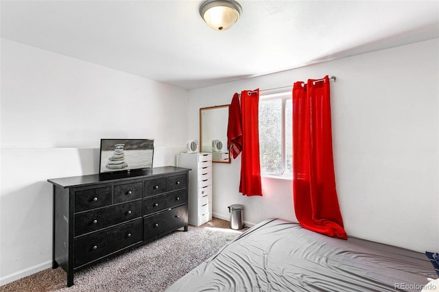 carpeted bedroom featuring baseboards