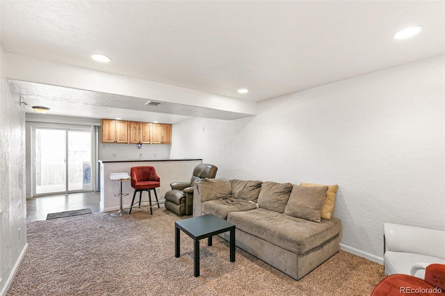 living room featuring light colored carpet, baseboards, recessed lighting, and a textured wall