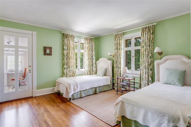 199 Lafayette St, Denver, CO 80218 - bedroom featuring multiple windows, wood finished floors, and crown molding