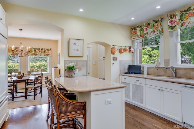 199 Lafayette St, Denver, CO 80218 - kitchen featuring dishwasher, arched walkways, a chandelier, wood finished floors, and recessed lighting