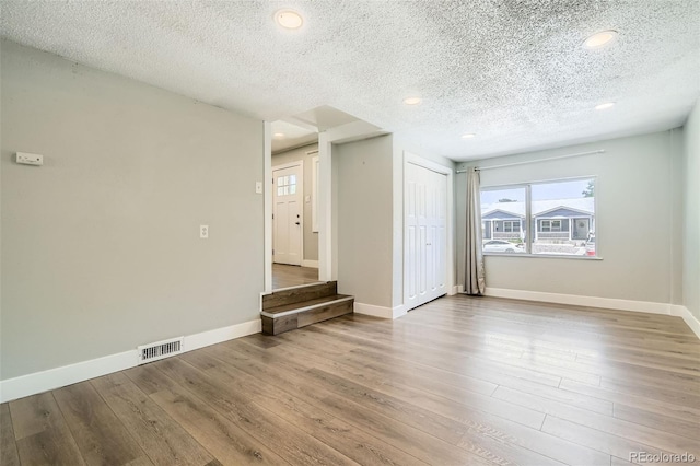 2726 W 1st Ave, Denver, CO 80219 - spare room with a textured ceiling, wood finished floors, and recessed lighting