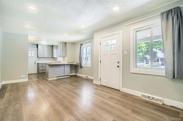 2726 W 1st Ave, Denver, CO 80219 - entrance foyer featuring a textured ceiling, wood finished floors, and recessed lighting