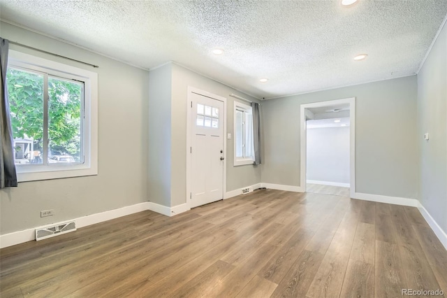2726 W 1st Ave, Denver, CO 80219 - foyer featuring plenty of natural light, wood finished floors, a textured ceiling, and recessed lighting