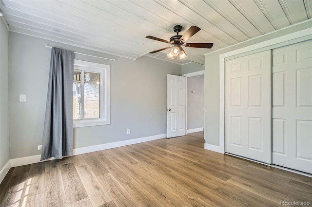 2726 W 1st Ave, Denver, CO 80219 - unfurnished bedroom featuring a closet, wood finished floors, wooden ceiling, and a ceiling fan