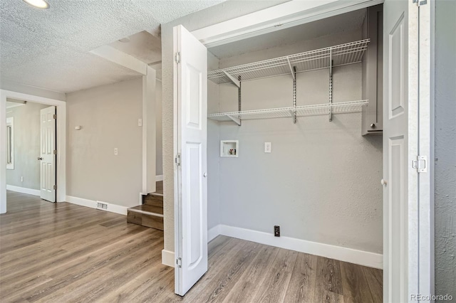 2726 W 1st Ave, Denver, CO 80219 - washroom with hookup for a washing machine, wood finished floors, and a textured ceiling