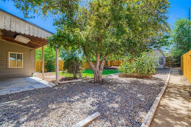 2726 W 1st Ave, Denver, CO 80219 - fenced backyard featuring a storage unit, a patio area, and a vegetable garden