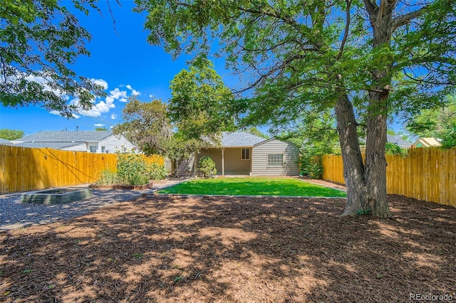 2726 W 1st Ave, Denver, CO 80219 - rear view of house featuring a fenced backyard, a garden, and a patio area