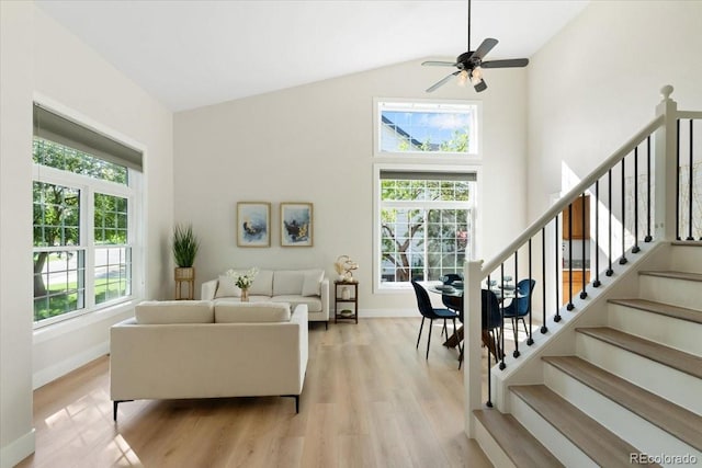 2089 Meadow Sweet Ln, Erie, CO 80516 - living area featuring light wood-type flooring, stairs, a ceiling fan, and high vaulted ceiling
