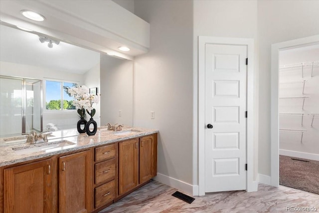 2089 Meadow Sweet Ln, Erie, CO 80516 - full bath with a shower stall, double vanity, a walk in closet, and marble finish floors