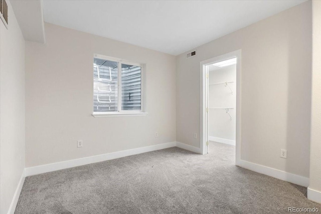 2089 Meadow Sweet Ln, Erie, CO 80516 - unfurnished bedroom with carpet, a walk in closet, and a closet